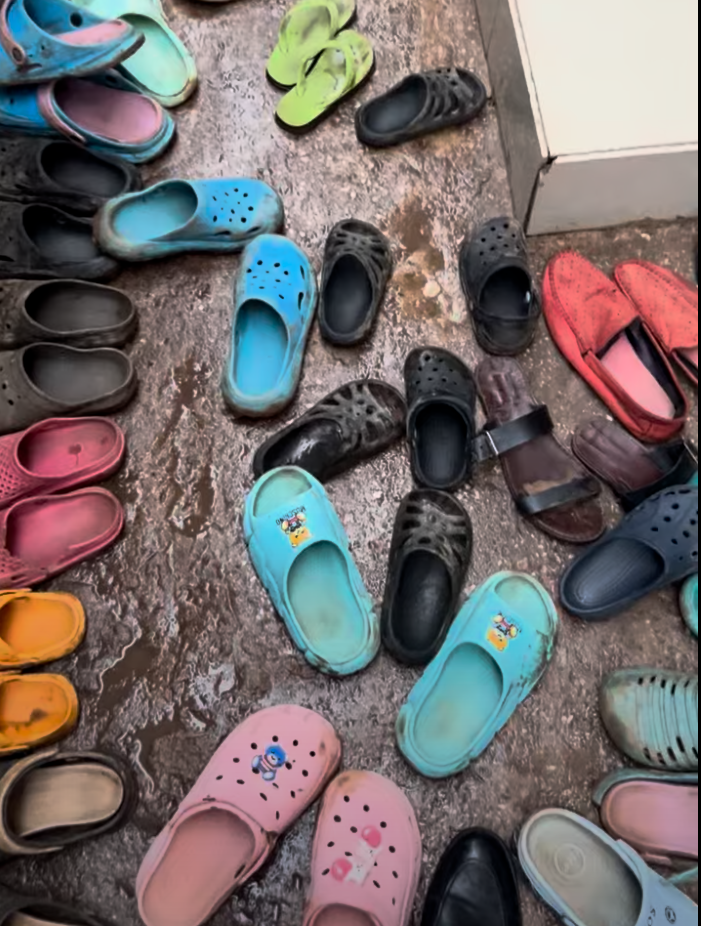Worn shoes left at the door of the school