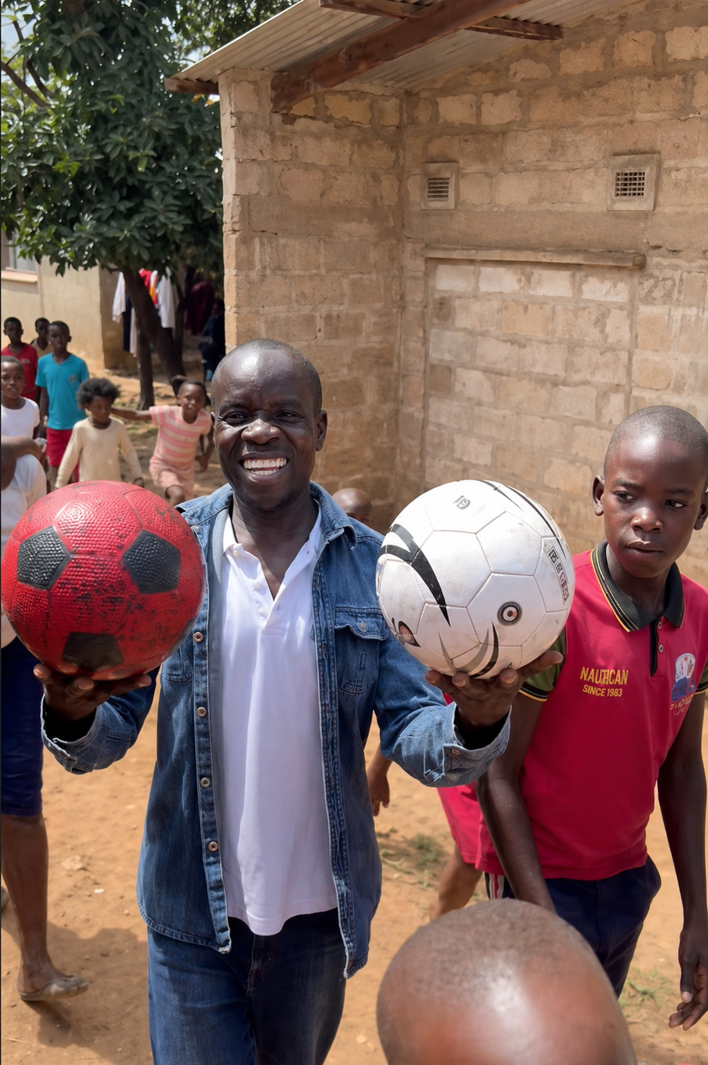 Mambwe, founder of Viking Primary School, with children