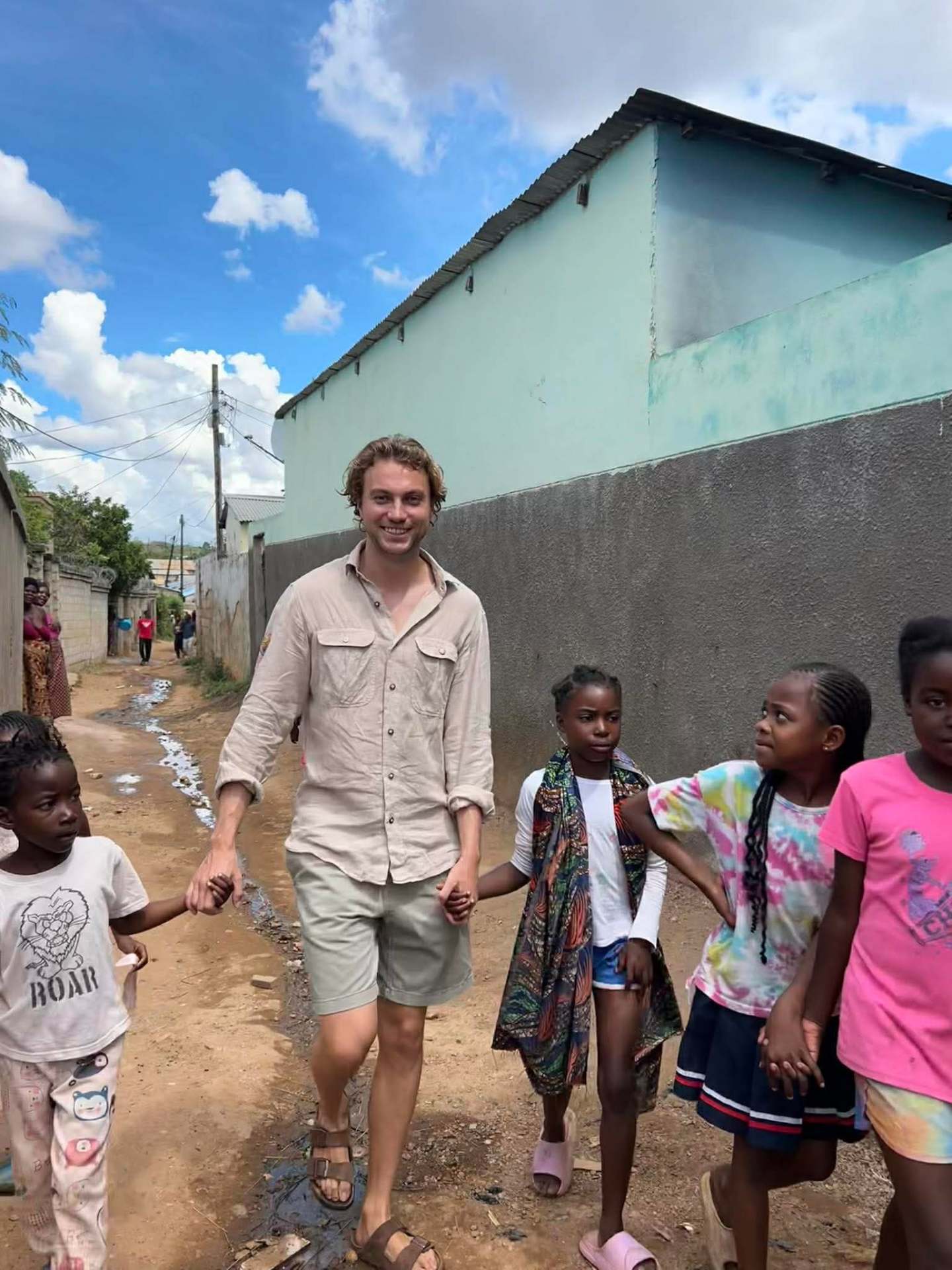 Volunteer walking with children in Lusaka